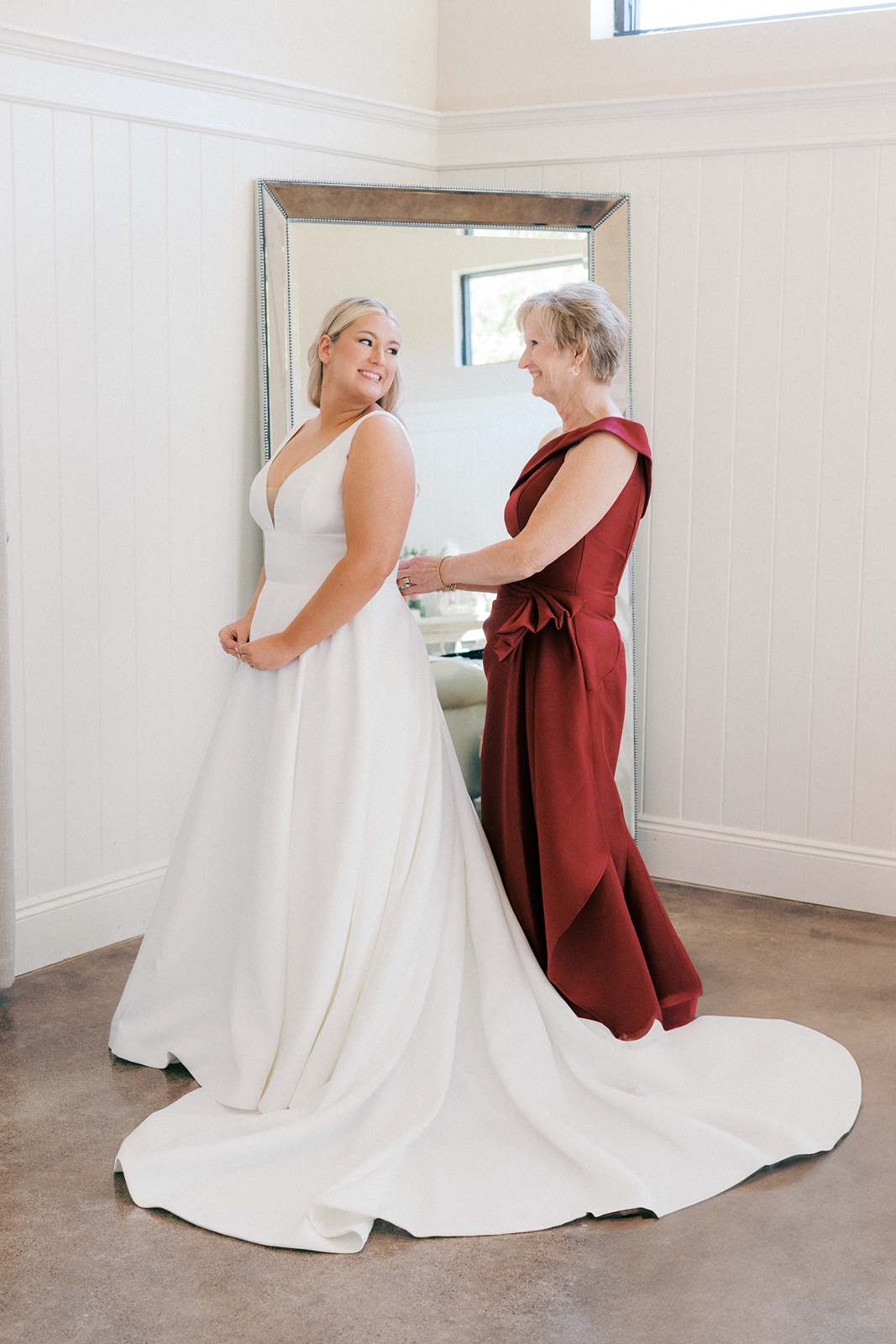 Bride getting into wedding dress at Greystone Estate