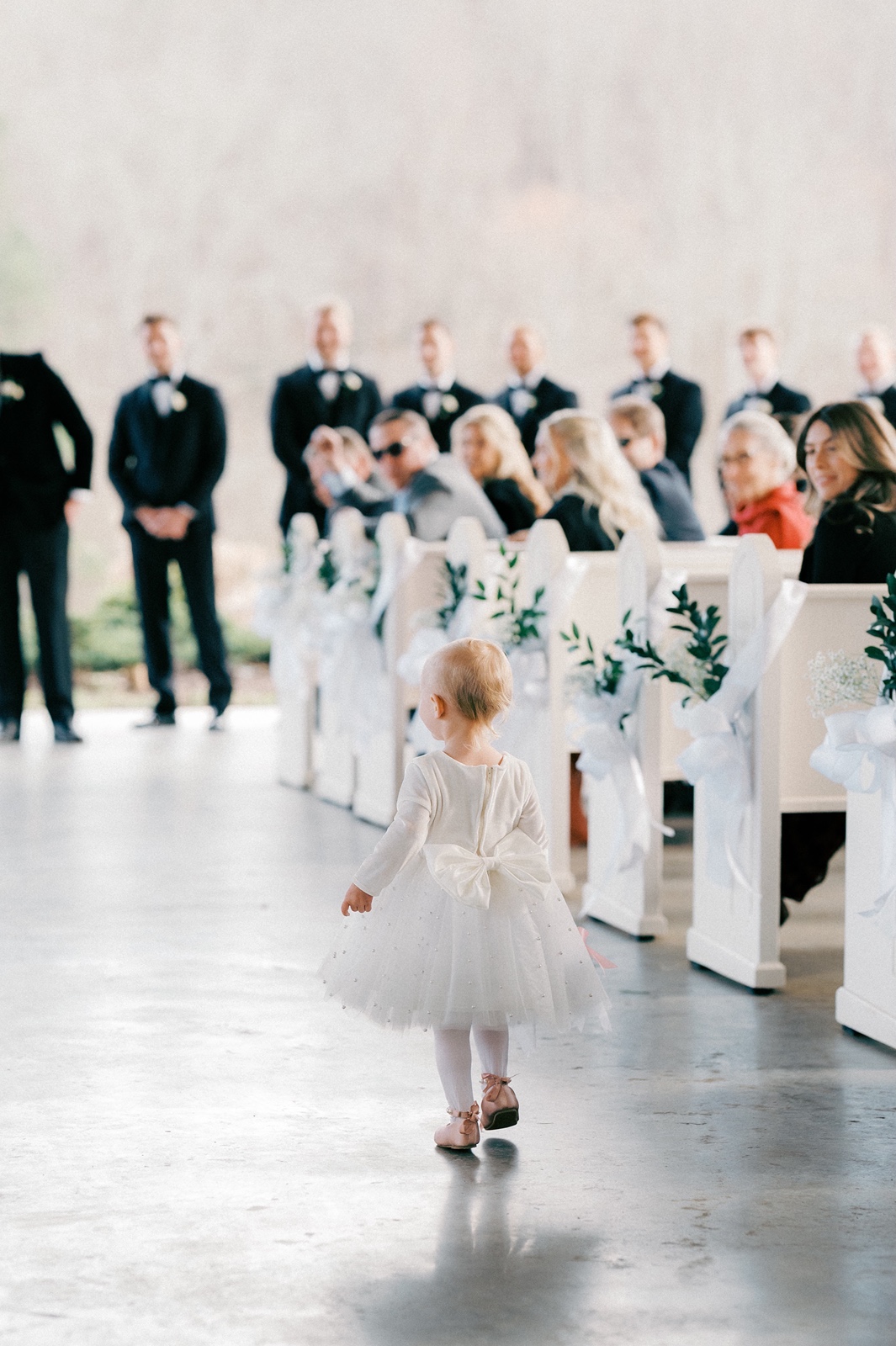 Flower girl walks down the aisle at Greystone Estate