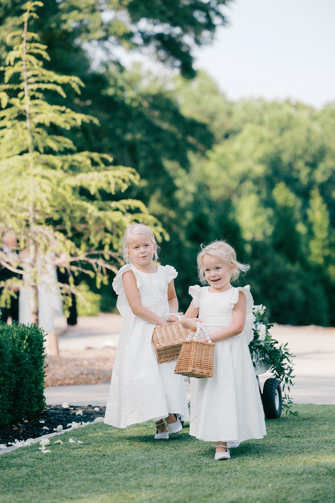 Flower girls in white dresses at the Hadden Estate wedding ceremony
